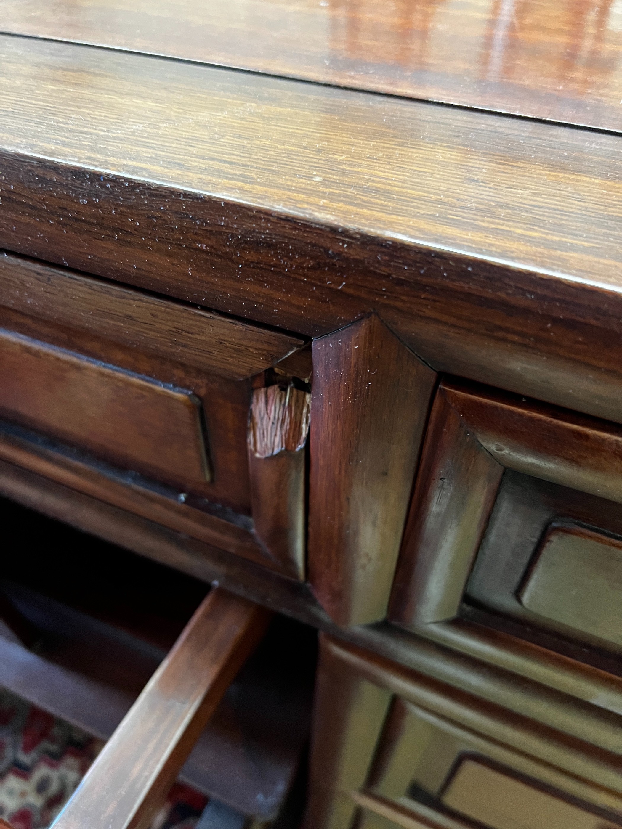 A Chinese hardwood kneehole desk, length 131cm, depth 65cm, height 83cm and elbow chair